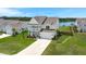 Picturesque two-story home with a front porch, attached garage, and a view of a lake at 682 Pontoon Rd, Huger, SC 29450
