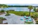 A lovely outdoor fire pit with Adirondack chairs overlooks a scenic lake and landscape at 682 Pontoon Rd, Huger, SC 29450