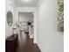 Bright foyer featuring hardwood floors, decorative mirror, and staircase leading to the upper level at 682 Pontoon Rd, Huger, SC 29450