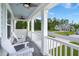 Inviting front porch with white Adirondack chairs and serene neighborhood views at 682 Pontoon Rd, Huger, SC 29450