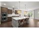 Modern kitchen with stainless steel appliances, a large island, and open dining area with access to the patio at 682 Pontoon Rd, Huger, SC 29450