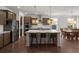 Contemporary kitchen featuring a large island with seating, stainless steel appliances, and modern lighting at 682 Pontoon Rd, Huger, SC 29450