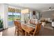 Dining room with a view of the living room, fireplace, and outdoor patio and lake at 682 Pontoon Rd, Huger, SC 29450