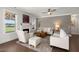 Comfortable living room featuring a fireplace, plush seating, and hardwood floors throughout at 682 Pontoon Rd, Huger, SC 29450