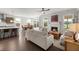 Open-concept living room connected to the kitchen, featuring a fireplace and views of the backyard at 682 Pontoon Rd, Huger, SC 29450