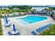 A bright blue swimming pool in a lakeside community with plenty of seating and shade at 682 Pontoon Rd, Huger, SC 29450