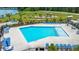 A top-down view of a bright blue community pool with plenty of seating and lake views at 682 Pontoon Rd, Huger, SC 29450