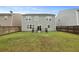 Green backyard, with a small patio area surrounded by a metal fence at 700 Silver Moss Dr, Moncks Corner, SC 29461