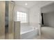 Clean bathroom showcasing a soaking tub under a window and a tiled standing shower at 700 Silver Moss Dr, Moncks Corner, SC 29461