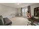 Spacious bedroom with carpet flooring, built-in desk, shelves, large windows and gaming chair at 700 Silver Moss Dr, Moncks Corner, SC 29461
