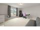 Bright bedroom with carpet flooring, built-in desk, shelves, large windows, and gray futon at 700 Silver Moss Dr, Moncks Corner, SC 29461
