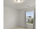Neutral bedroom featuring a window with gray patterned curtains and view of neighborhood at 700 Silver Moss Dr, Moncks Corner, SC 29461