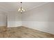 Charming dining room features decorative wainscoting, wood floors, and elegant chandelier at 700 Silver Moss Dr, Moncks Corner, SC 29461