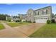 Two-story home with a manicured front yard and a spacious driveway at 700 Silver Moss Dr, Moncks Corner, SC 29461