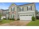 Well-maintained home featuring a two-car garage and landscaped front yard at 700 Silver Moss Dr, Moncks Corner, SC 29461