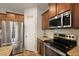 Kitchen area with stainless steel microwave and oven, granite counters and wooden cabinets at 700 Silver Moss Dr, Moncks Corner, SC 29461