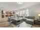 Open-concept living area flows into the kitchen, featuring a large sectional sofa at 700 Silver Moss Dr, Moncks Corner, SC 29461