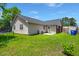 This home's backyard has ample space with a grassy lawn, trampoline, and space to relax at 7733 Buck Pond Rd, North Charleston, SC 29418