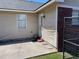 Backyard area with a patio, door to the house, and a brick section of the exterior at 7733 Buck Pond Rd, North Charleston, SC 29418