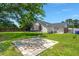 The backyard shows a grassy lawn, trampoline, and patio space to relax at 7733 Buck Pond Rd, North Charleston, SC 29418