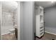 This is a view of the remodeled bathroom, showing the tile shower, toilet and custom shelving at 7733 Buck Pond Rd, North Charleston, SC 29418