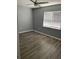 Modern bedroom with grey walls, a ceiling fan, and a window with blinds at 7733 Buck Pond Rd, North Charleston, SC 29418