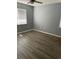 Simple bedroom with ceiling fan, window, and light brown wood flooring at 7733 Buck Pond Rd, North Charleston, SC 29418
