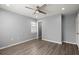 The bedroom is newly remodeled, offering hardwood floors, ceiling fan, a sun-lit window and an entry door at 7733 Buck Pond Rd, North Charleston, SC 29418