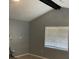 Living room with a vaulted ceiling, modern fan, and window with blinds at 7733 Buck Pond Rd, North Charleston, SC 29418