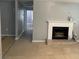 Bright living room with fireplace, tile floors, and hallway leading to a bathroom at 7733 Buck Pond Rd, North Charleston, SC 29418