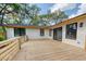 Spacious backyard deck is perfect for outdoor entertaining with mature trees in the distance at 841 Fred St, Charleston, SC 29412