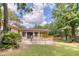 Exterior view of the backyard featuring a deck, covered porch, and well-maintained lawn at 841 Fred St, Charleston, SC 29412