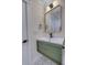 Modern bathroom featuring patterned floor tiles, green vanity with gold trim, and sleek fixtures at 841 Fred St, Charleston, SC 29412