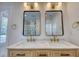 Bathroom vanity featuring double sinks, marble countertop, modern lighting, and black framed mirrors at 841 Fred St, Charleston, SC 29412
