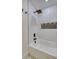 Modern bathroom featuring a tub, white subway tile, a dark shower head, and a built-in shelf at 841 Fred St, Charleston, SC 29412