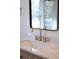 Close-up of a modern bathroom sink with marble countertop and gold faucet at 841 Fred St, Charleston, SC 29412