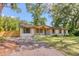 A single-story home featuring a brick exterior and a well-maintained front yard and driveway at 841 Fred St, Charleston, SC 29412