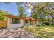 A beautiful single-story home featuring a brick exterior and a well-maintained front yard and driveway at 841 Fred St, Charleston, SC 29412