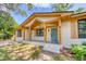 Charming single-story home featuring a white brick exterior, wood accents, and a inviting front porch at 841 Fred St, Charleston, SC 29412
