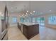 Open concept kitchen with stainless steel appliances, island, and light-colored hardwood floors at 841 Fred St, Charleston, SC 29412