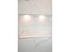 Bright and modern shower with white marble tiling and a built-in shelf niche provides luxury at 841 Fred St, Charleston, SC 29412