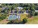 Gorgeous aerial view of community amenities including tennis courts and a large swimming pool at 8662 W Fairway Woods Dr, North Charleston, SC 29420