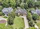 Stunning aerial view of a two-story brick home with lush landscaping and a long, private driveway at 8662 W Fairway Woods Dr, North Charleston, SC 29420