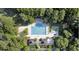 Aerial view of a sparkling swimming pool, playground, and outdoor picnic and lounge areas at 8662 W Fairway Woods Dr, North Charleston, SC 29420