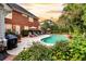 Relaxing backyard with a private pool, patio, lounge chairs, and mature landscaping at 8662 W Fairway Woods Dr, North Charleston, SC 29420
