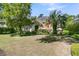 Large backyard featuring mature trees, palms, and lush landscaping at 8662 W Fairway Woods Dr, North Charleston, SC 29420