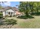 Beautiful backyard with lush greenery, patio area, and well-maintained lawn at 8662 W Fairway Woods Dr, North Charleston, SC 29420