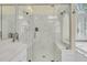 Spacious walk-in shower with marble surround and glass door at 8662 W Fairway Woods Dr, North Charleston, SC 29420