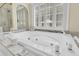 Luxurious soaking tub complete with marble surround and swan detail at 8662 W Fairway Woods Dr, North Charleston, SC 29420