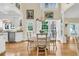 Cozy breakfast nook with garden view, features white cabinetry and an elegant chandelier at 8662 W Fairway Woods Dr, North Charleston, SC 29420